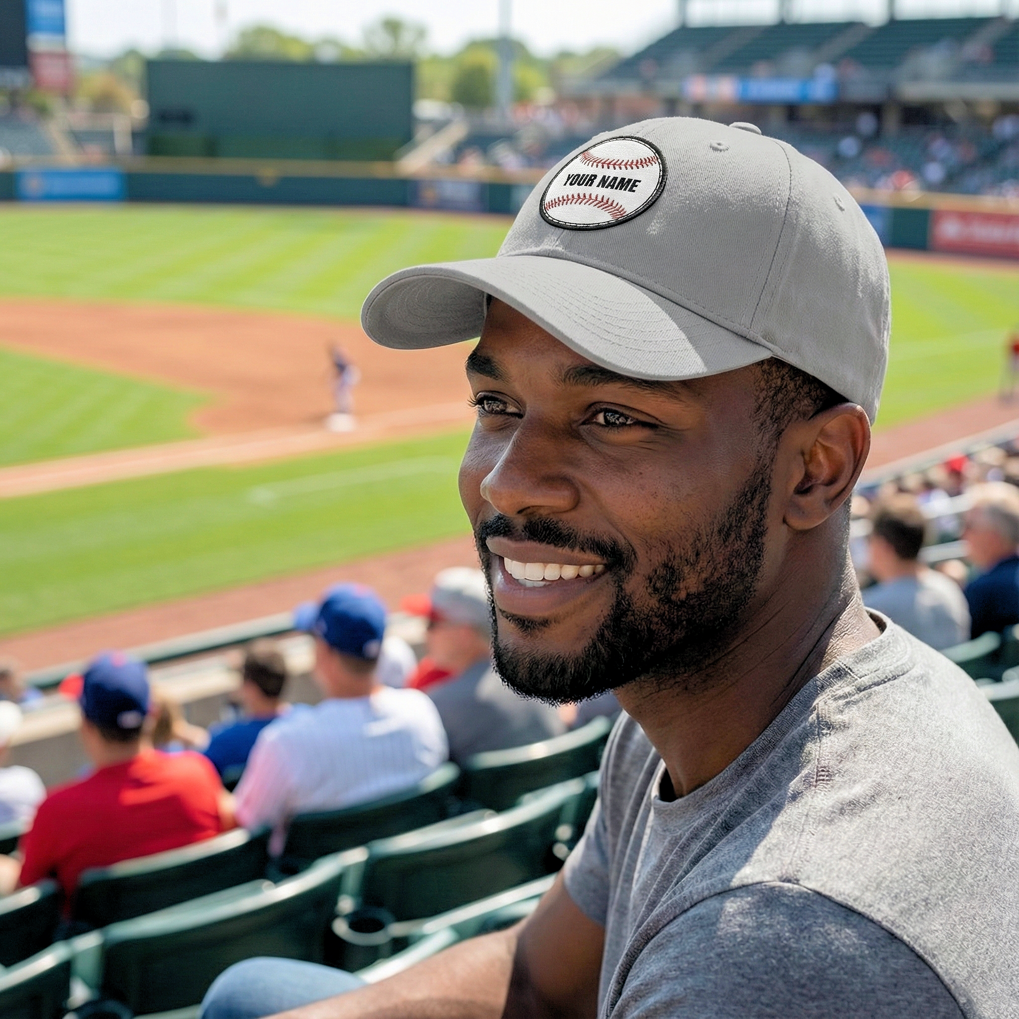 Baseball fan wearing hat sitting in stadium watching game on sunny day
