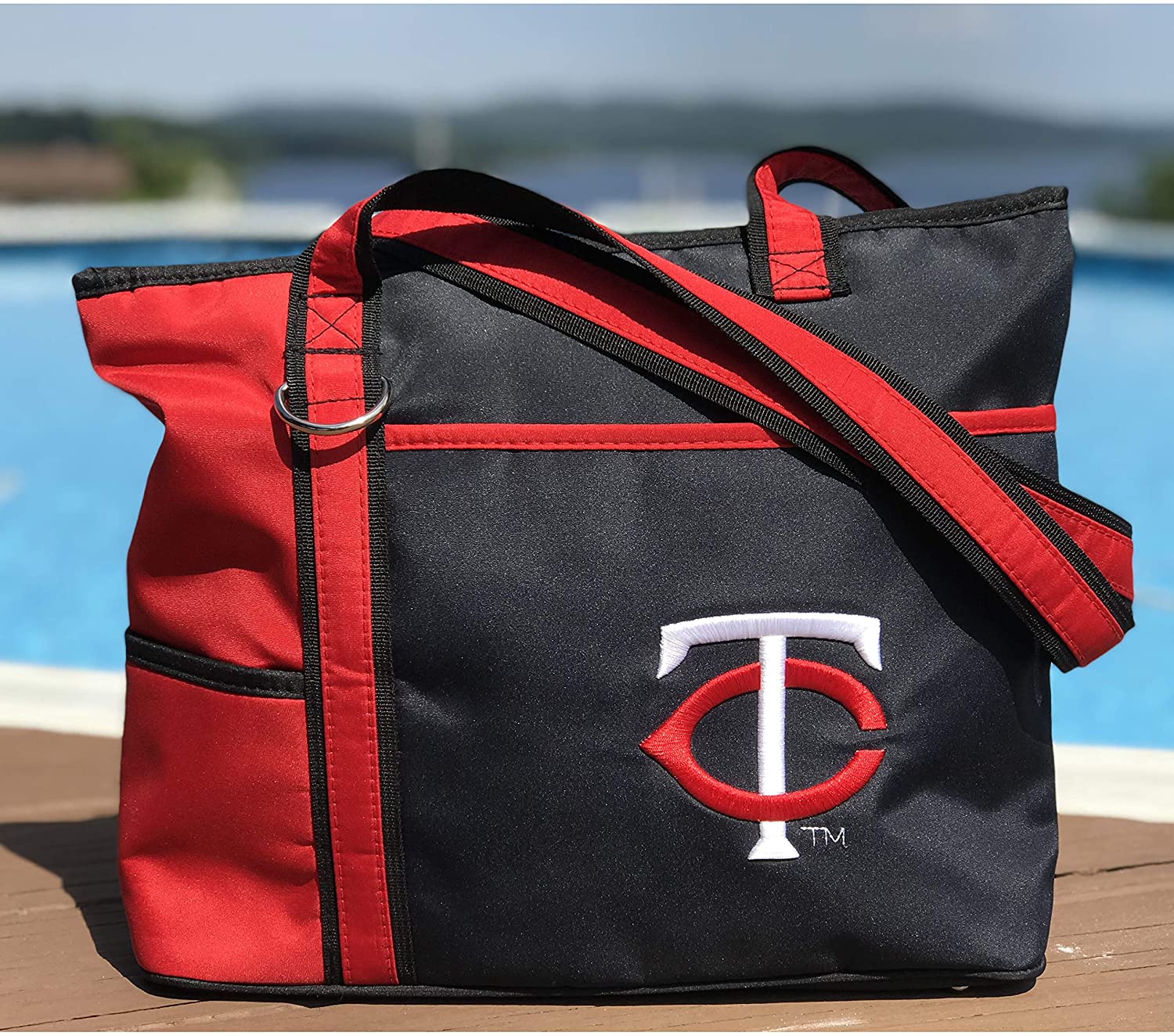 Minnesota Twins tote bag with a logo on a wooden surface by a pool