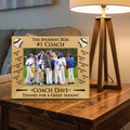 Wooden baseball coach and team photo frame with engraved text and photo of a baseball team on a wooden surface.