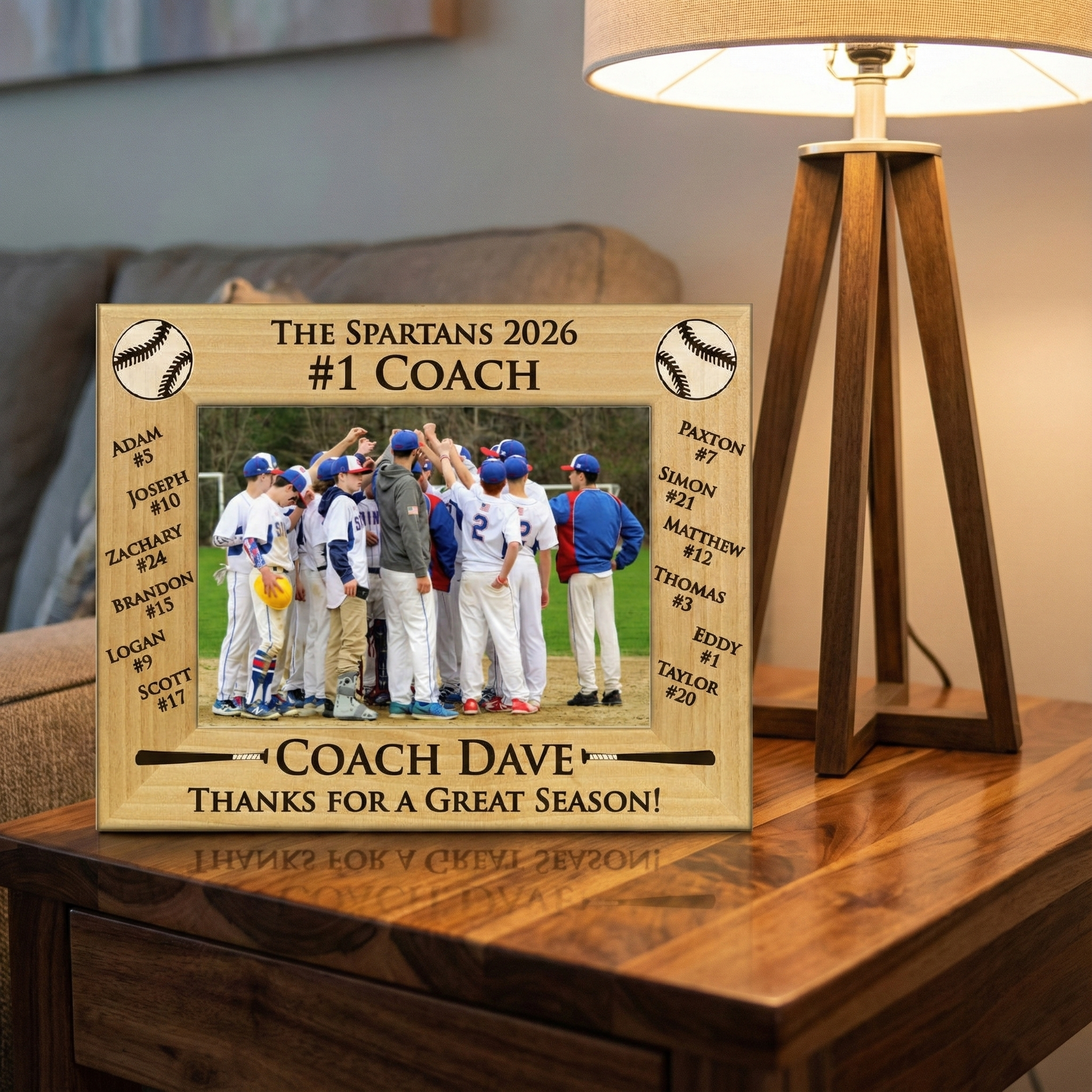 Wooden baseball coach and team photo frame with engraved text and photo of a baseball team on a wooden surface.