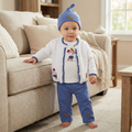 Baby in a blue and white boutique baseball outfit standing in a living room.