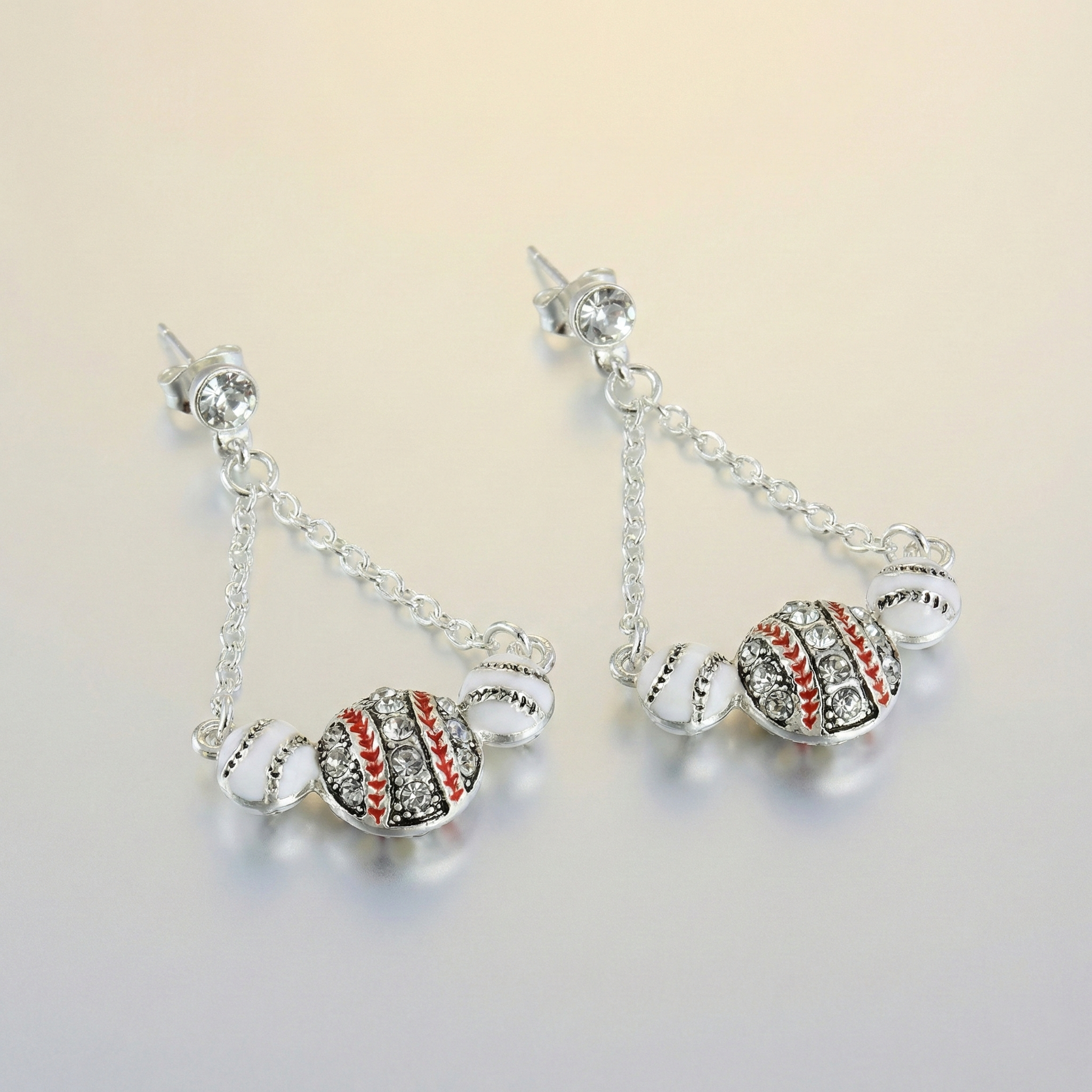 Pair of baseball drop earrings on a light background