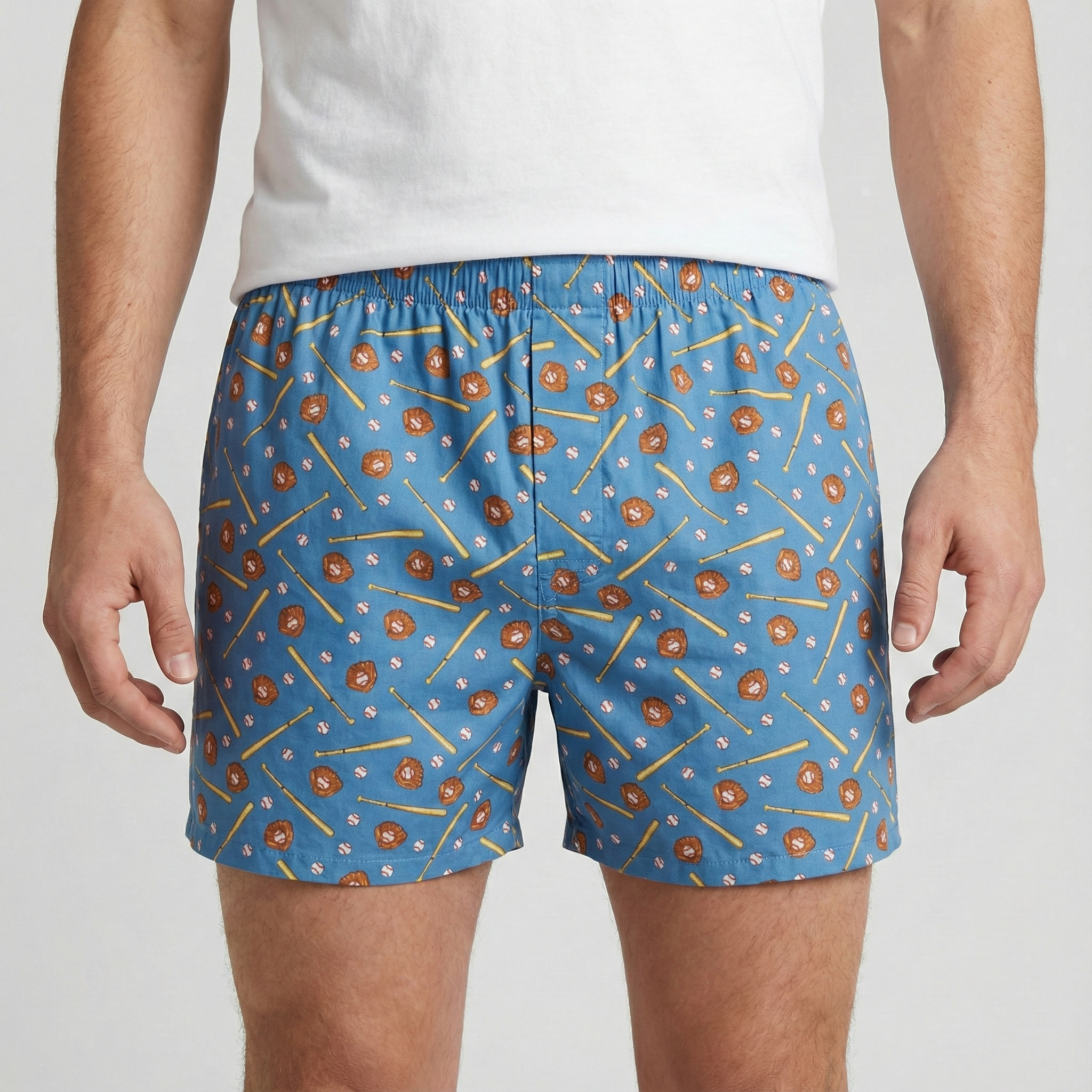Blue boxer shorts with a baseball pattern worn by a person on a white background