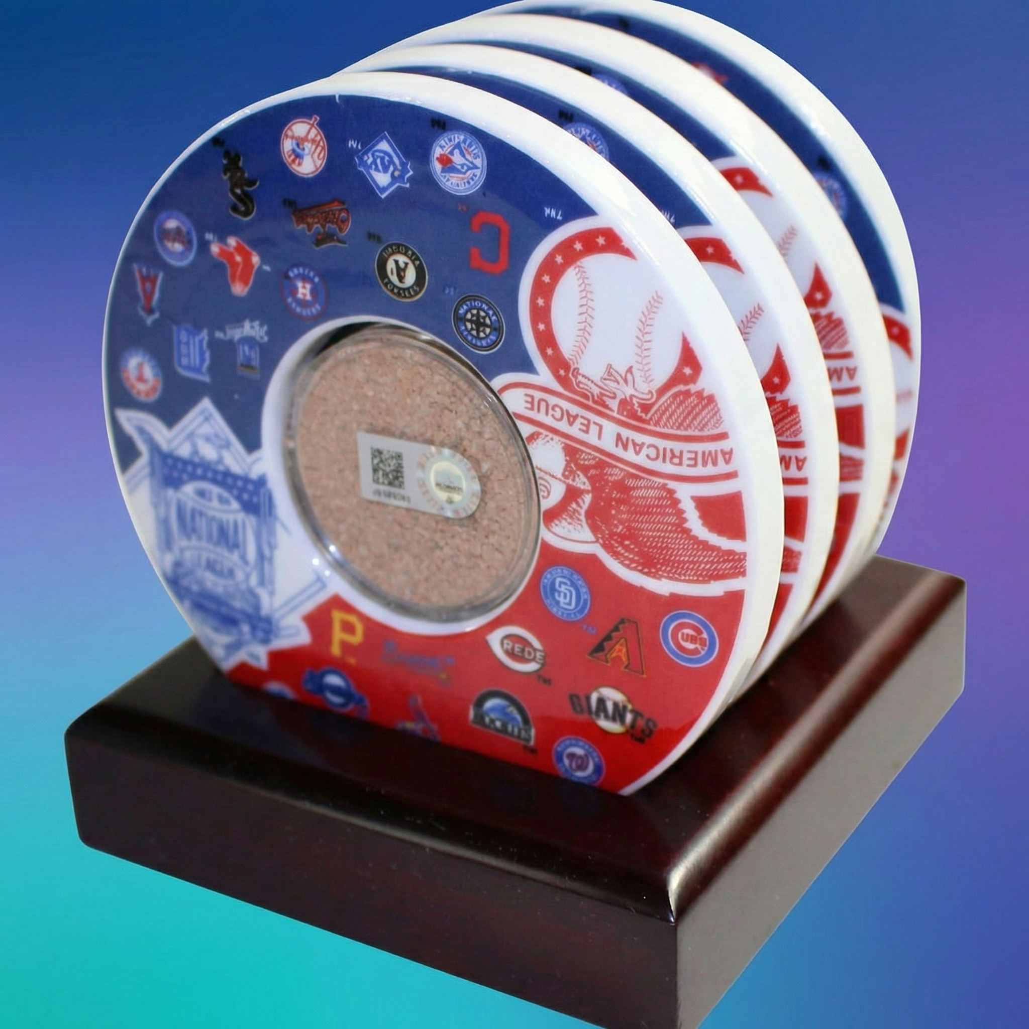 Set of four game used MLB baseball coasters on a wooden stand with a gradient background