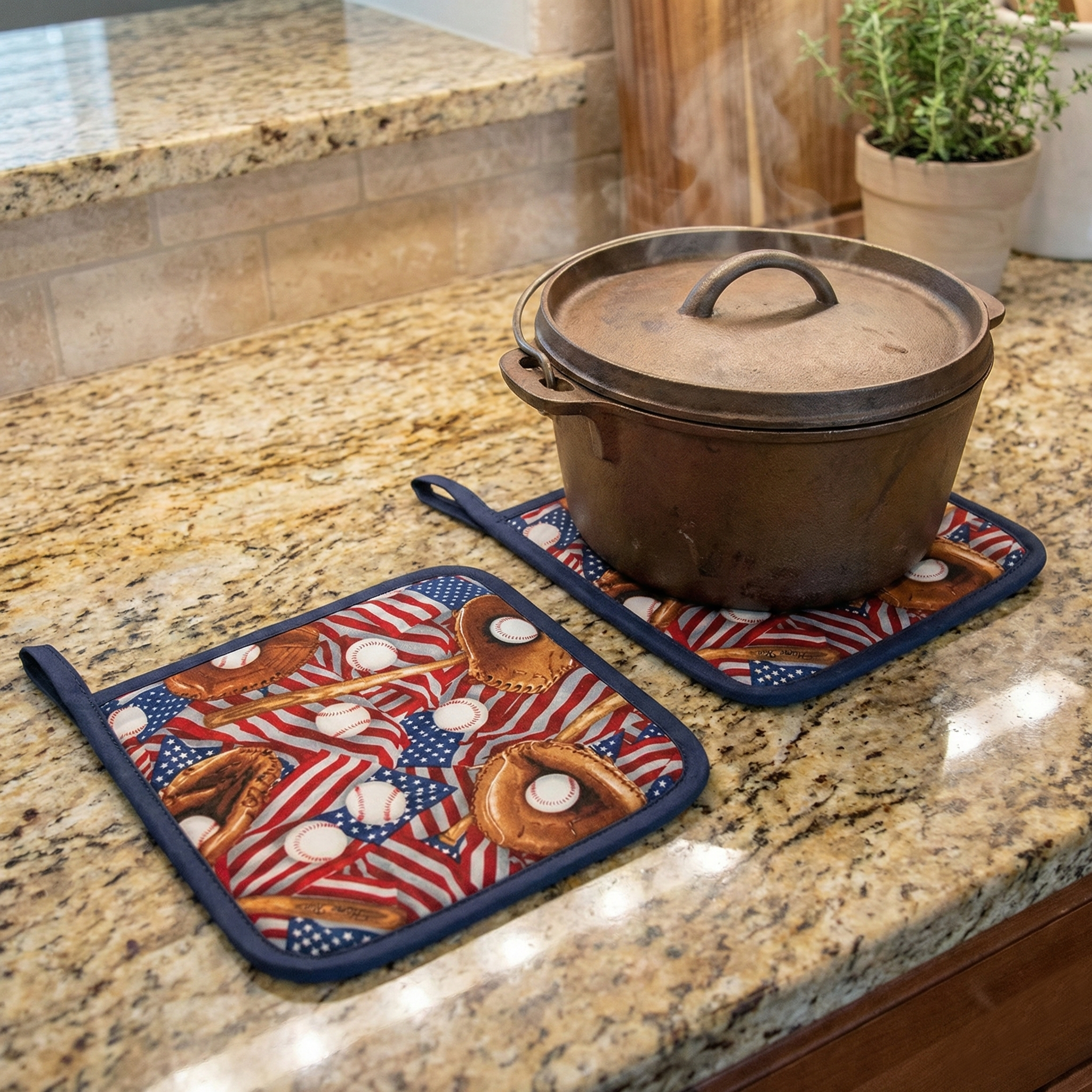Ceramic pot with lid on a granite countertop with decorative baseball potholders.