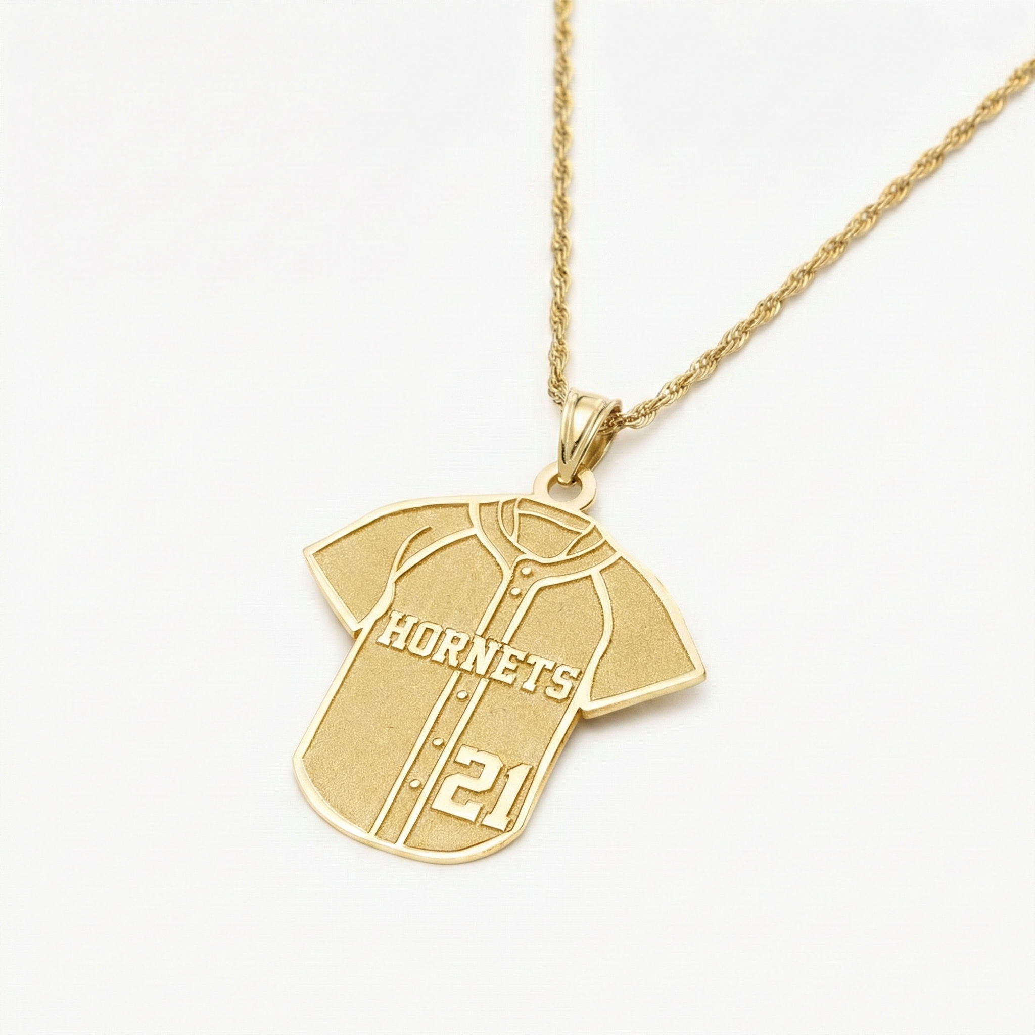 Gold baseball jersey necklace with a pendant shaped like a sports jersey on a white background