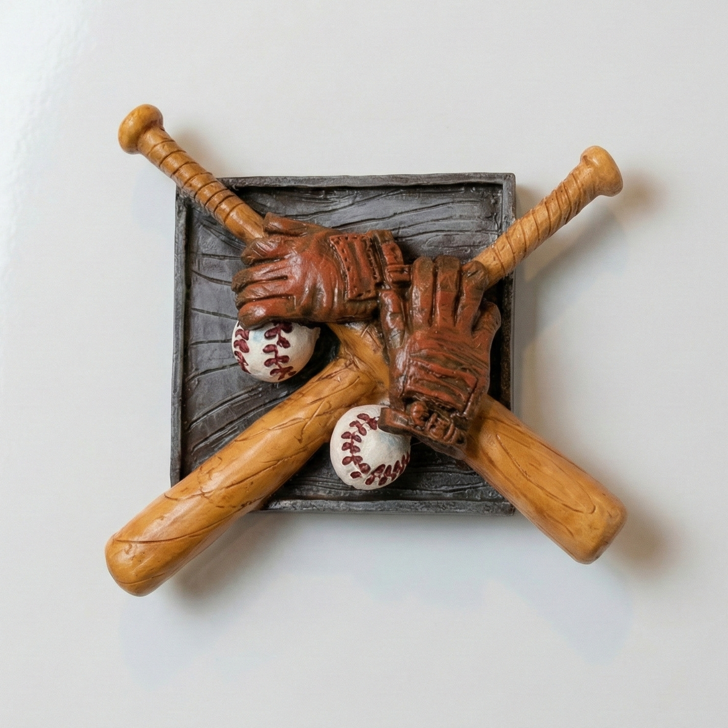 Decorative resin magnet with baseball bats, gloves, and balls on white surface.