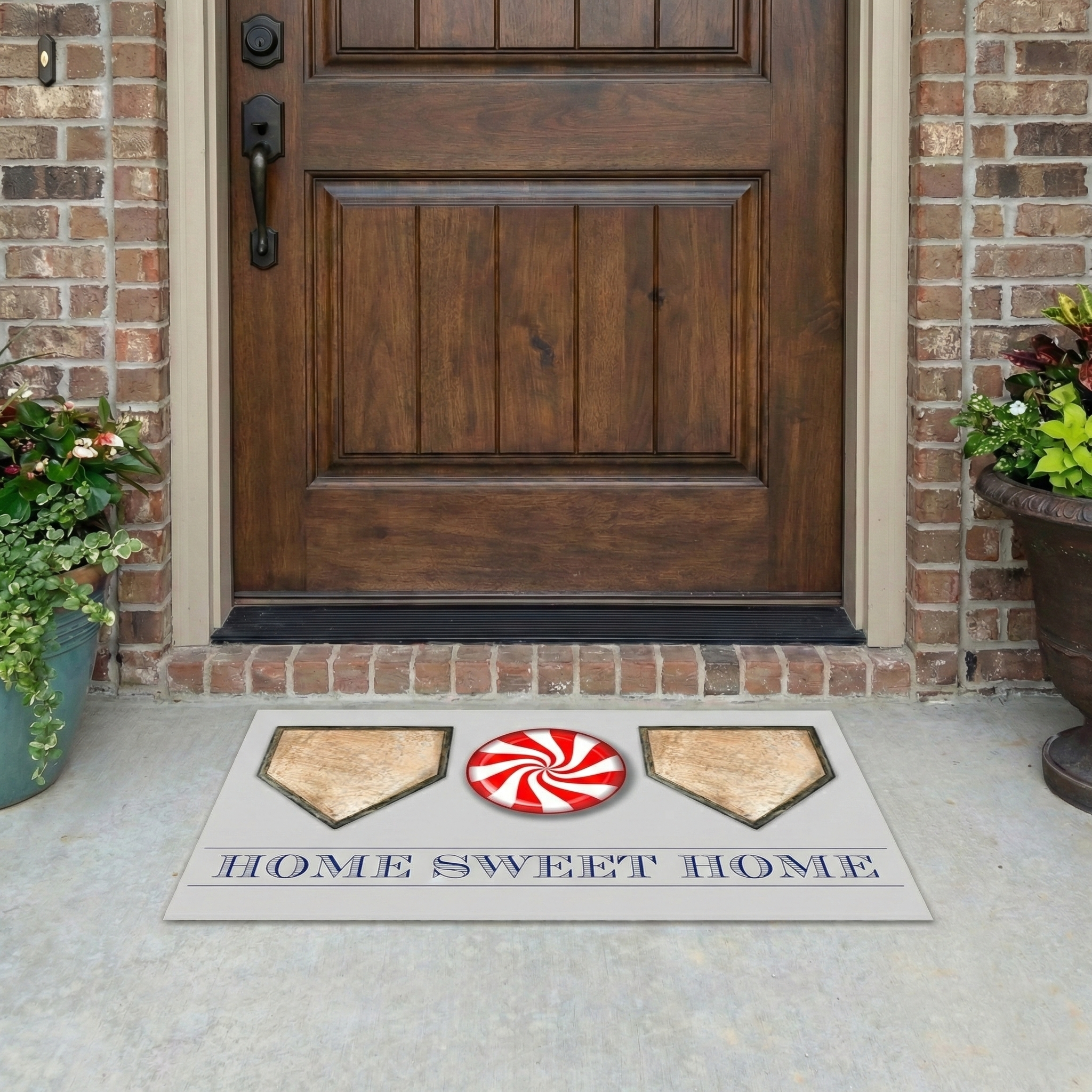 Doormat with baseball design and 'Home Sweet Home' text in front of a wooden door.