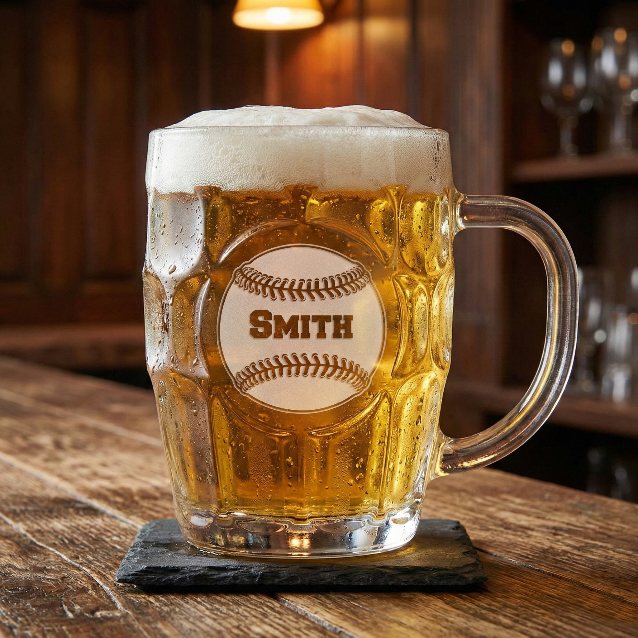 Custom baseball glass mug with cold beer and 'Smith' engraving on a wooden surface