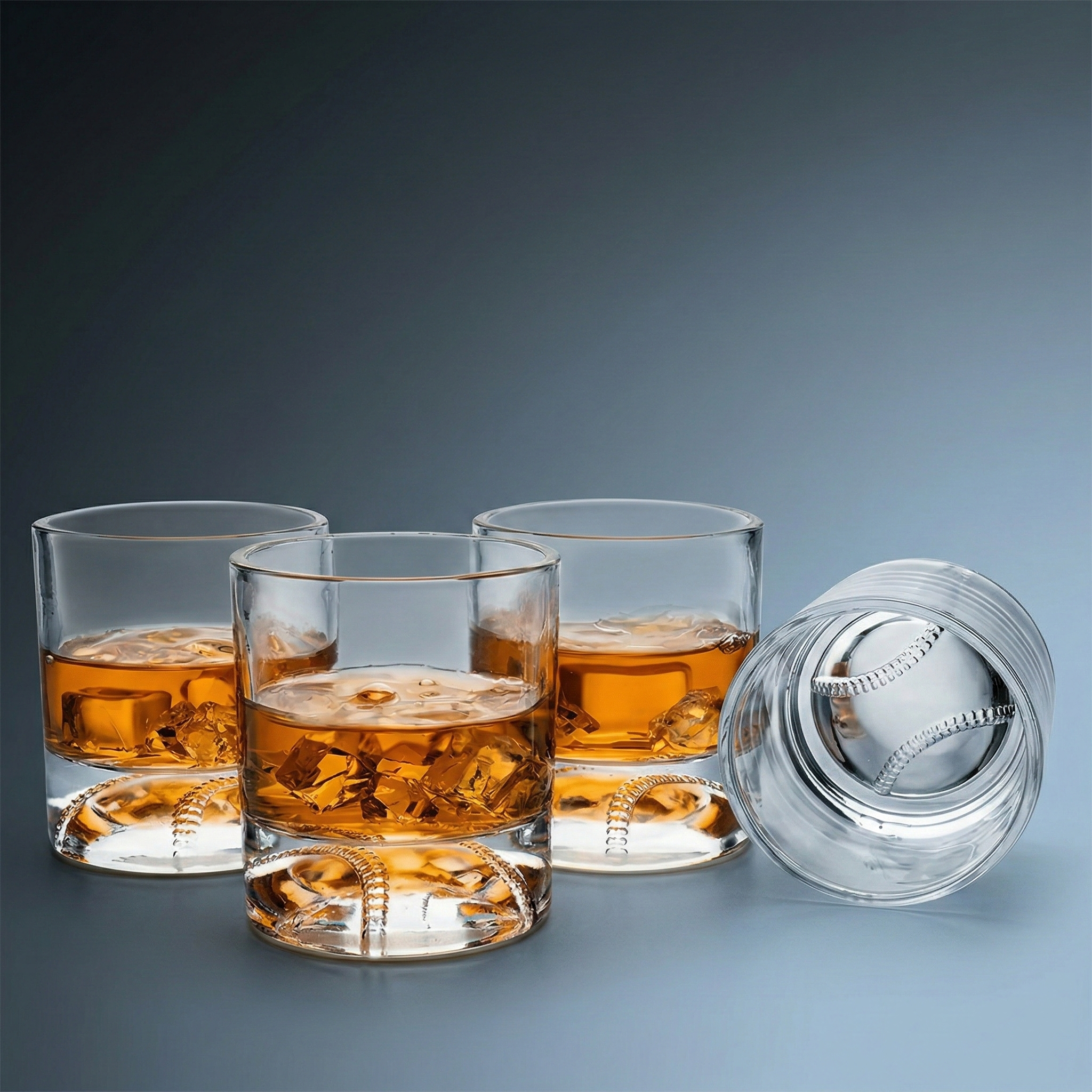 Set of clear baseball whiskey glasses on a gradient gray background