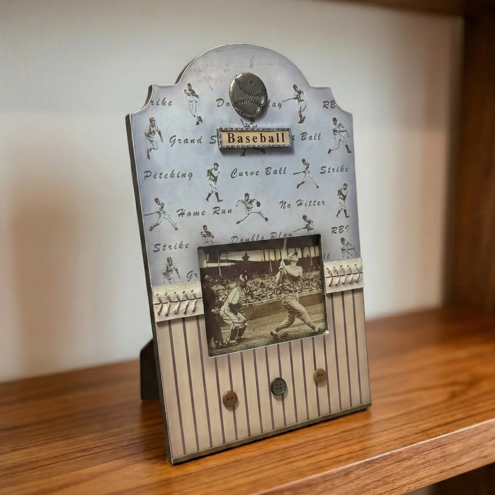 Baseball-themed photo frame with vintage baseball scene on a wooden surface