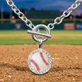 Baseball-themed toggle bracelet charm on a baseball field