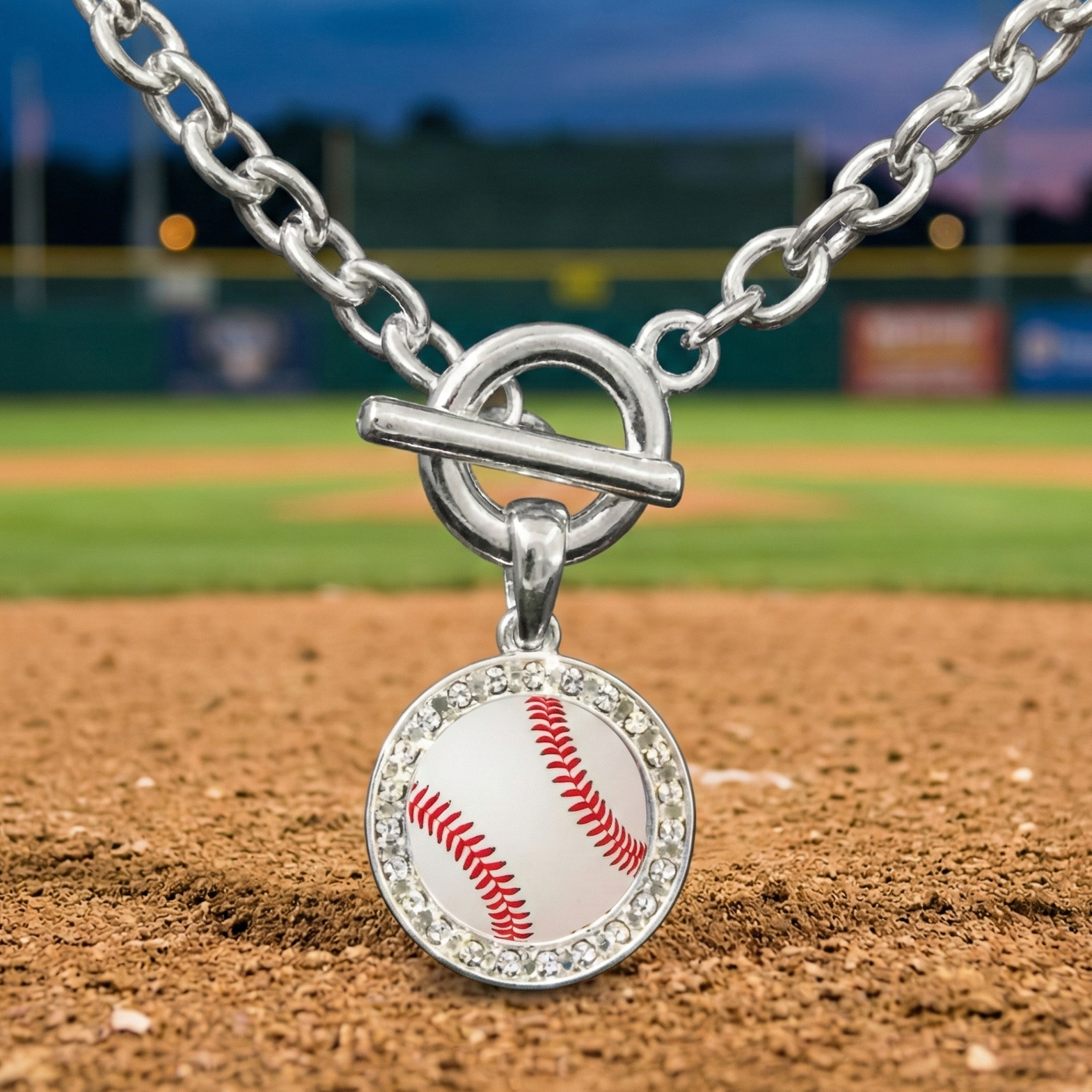 Baseball-themed toggle bracelet charm on a baseball field