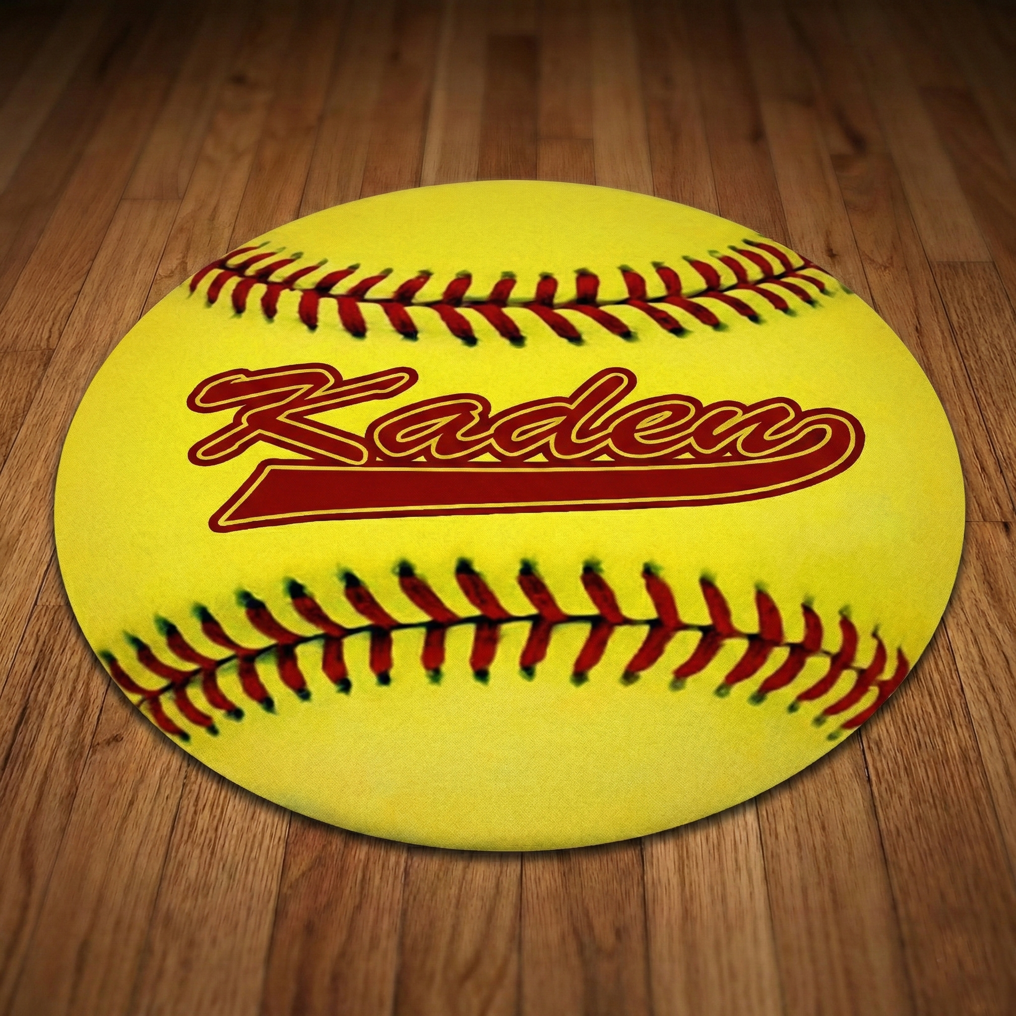 Yellow softball flat floor mat with red stitching and 'Kaden' branding on a wooden floor.