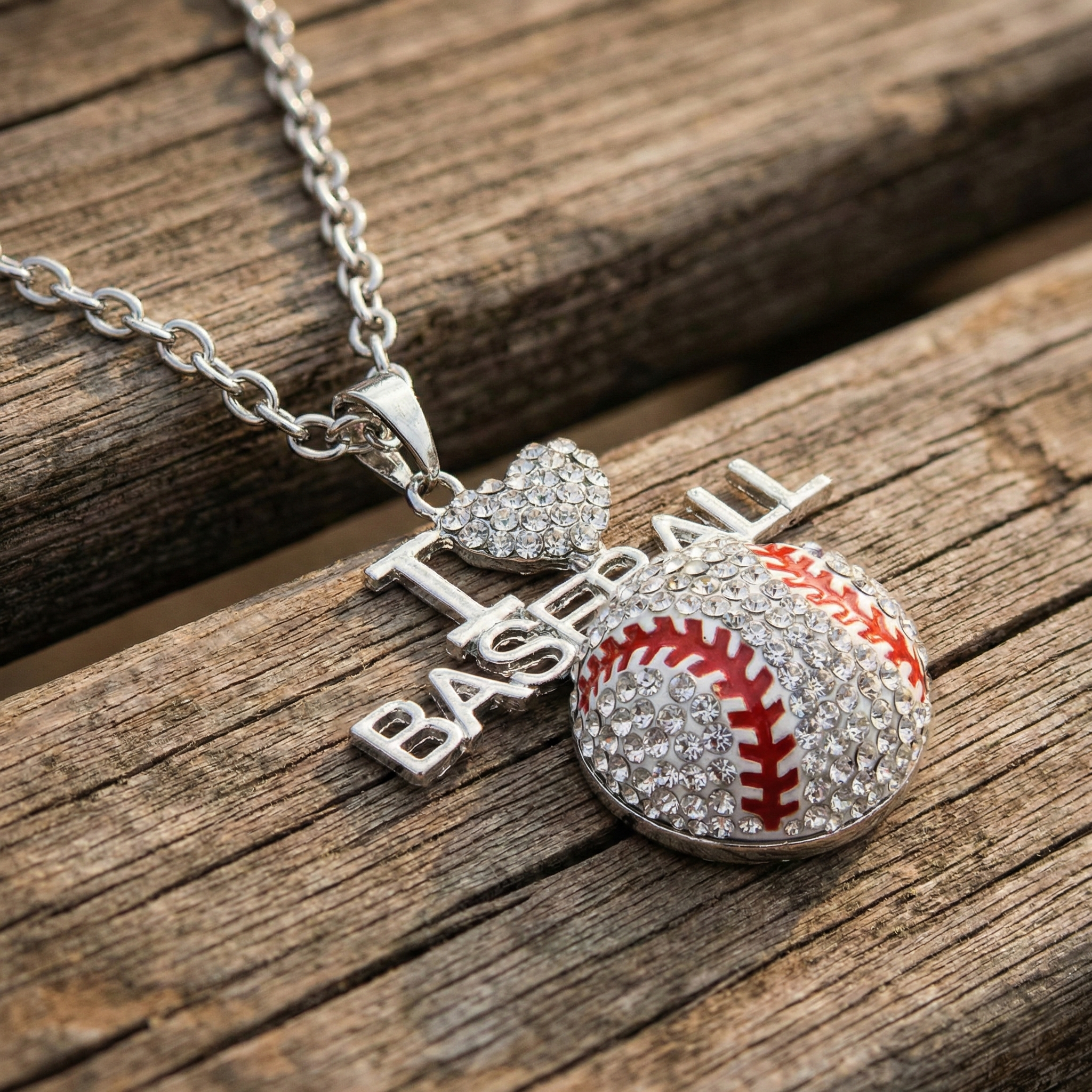 Silver necklace with a I heart baseball crystal pendant on a wooden surface