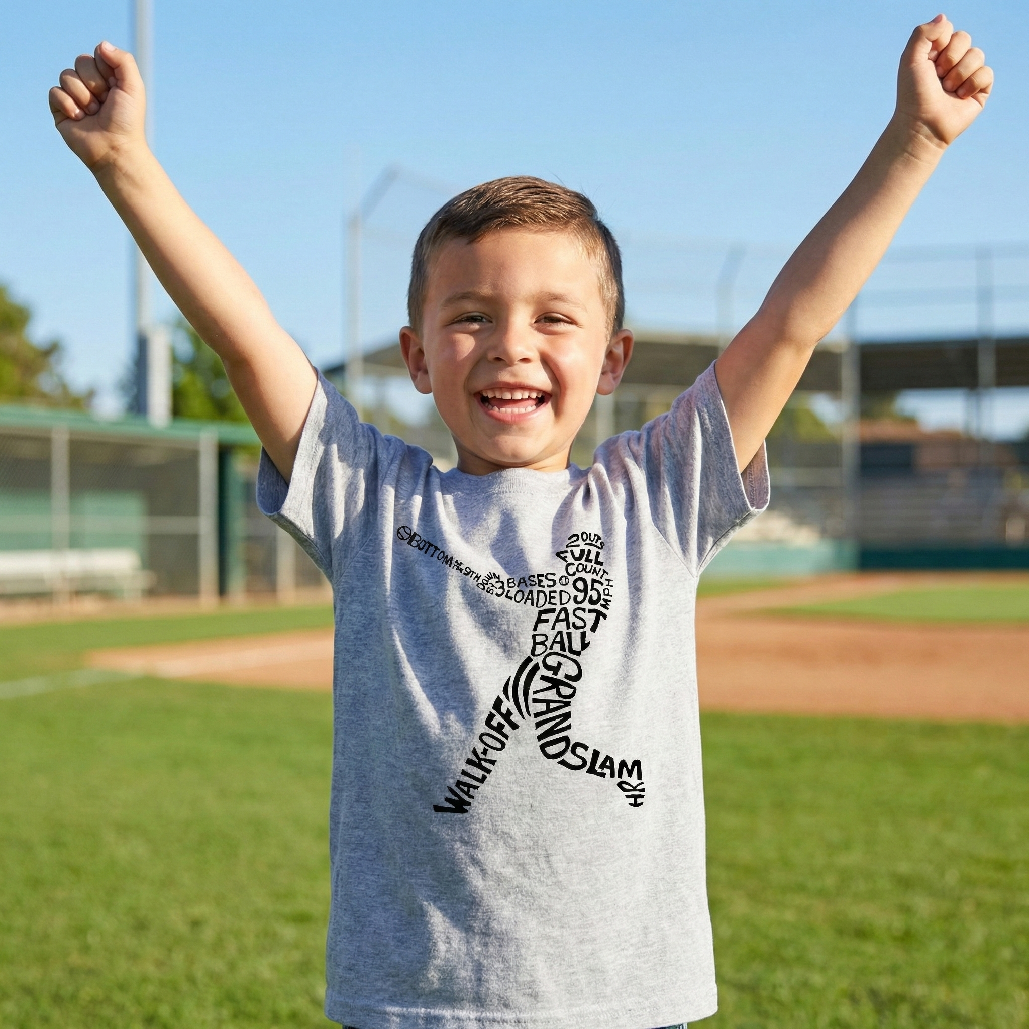 Child on a baseball field wearing a baseball batter t-shirt with text, arms raised