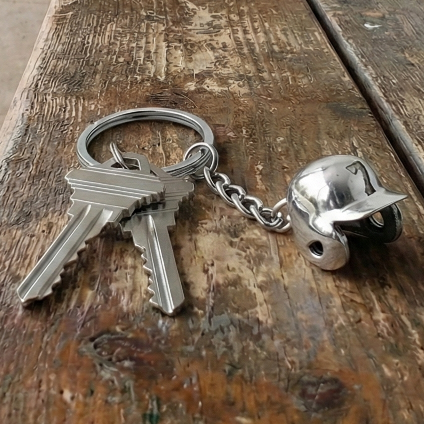 Keychain with keys and baseball number batters helmet charm on a wooden surface