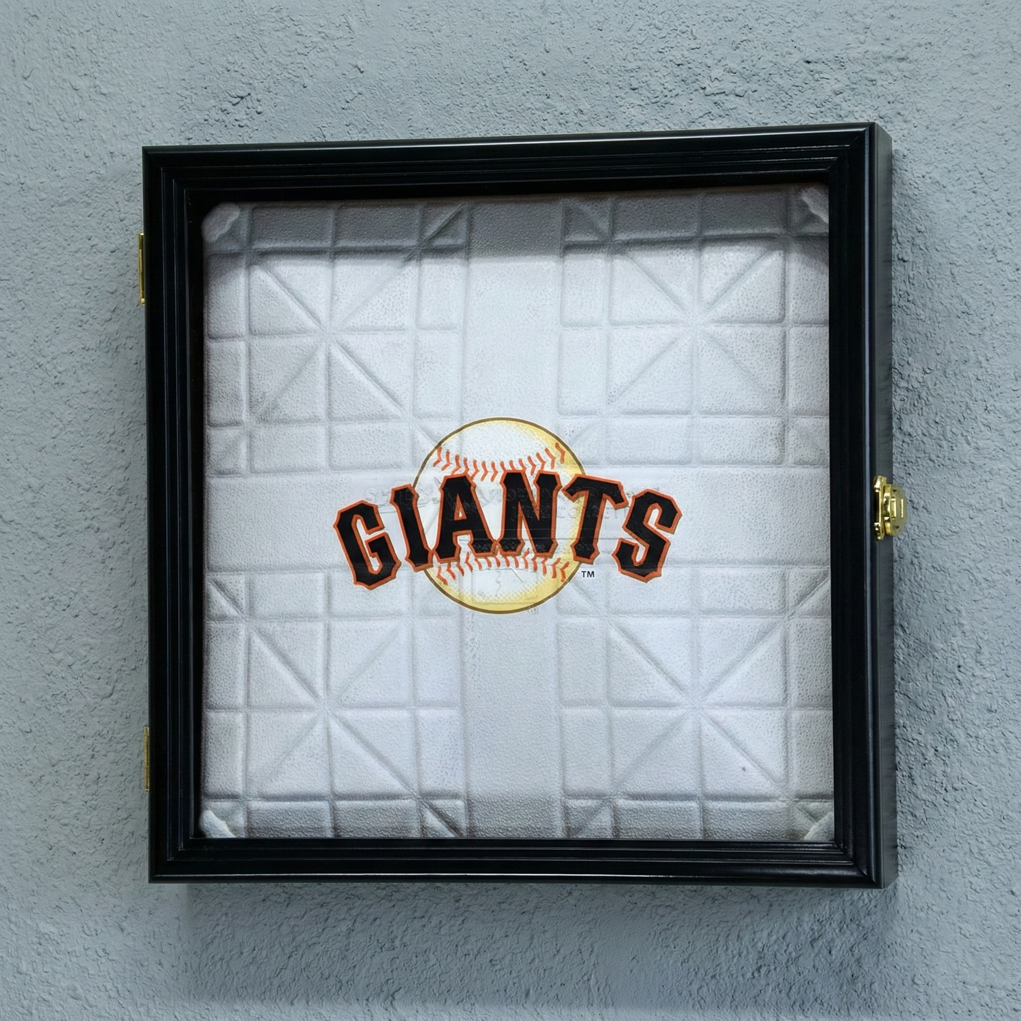 Framed baseball field base with 'Giants' logo on a gray wall