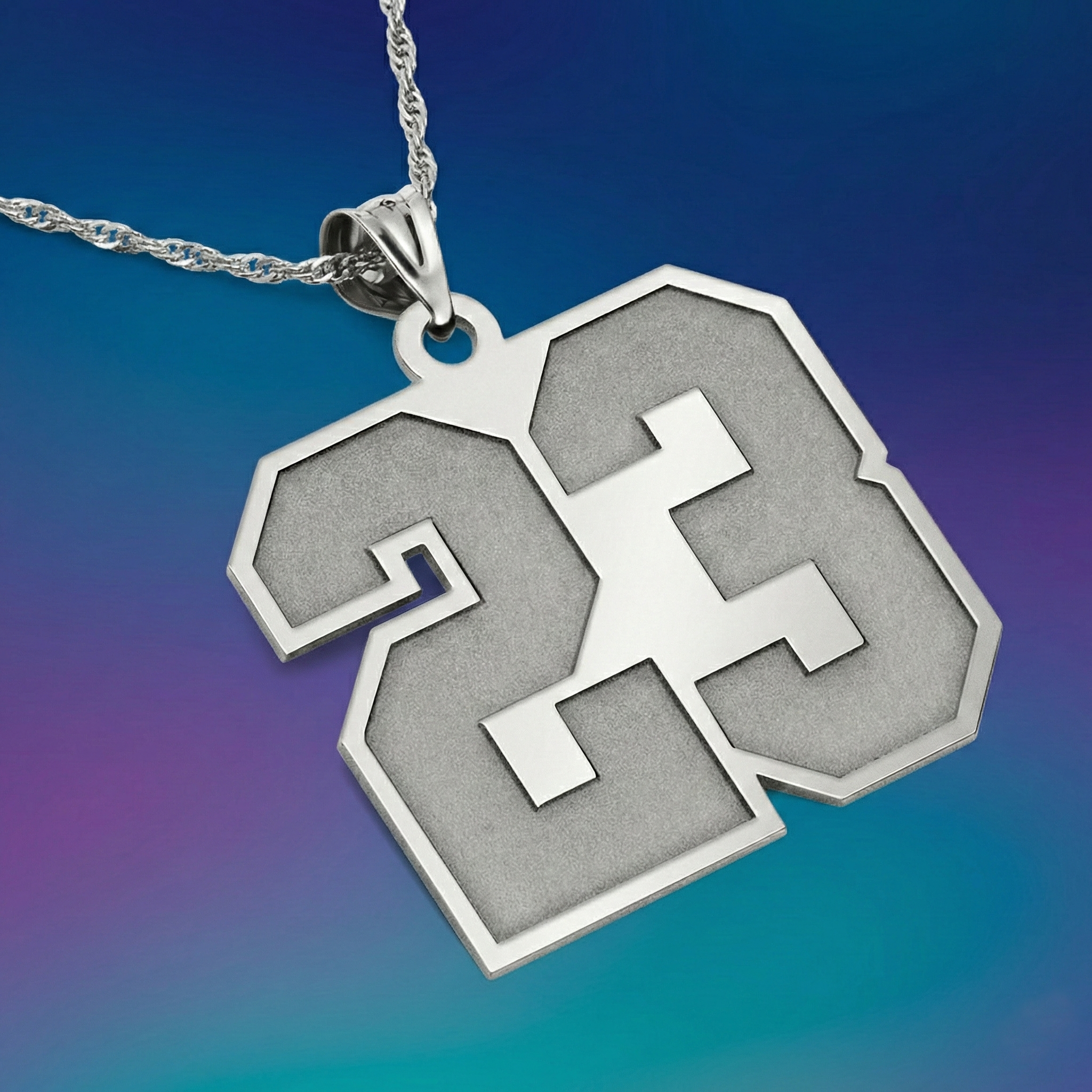 Silver necklace with the sports number 23 pendant on a gradient blue and purple background