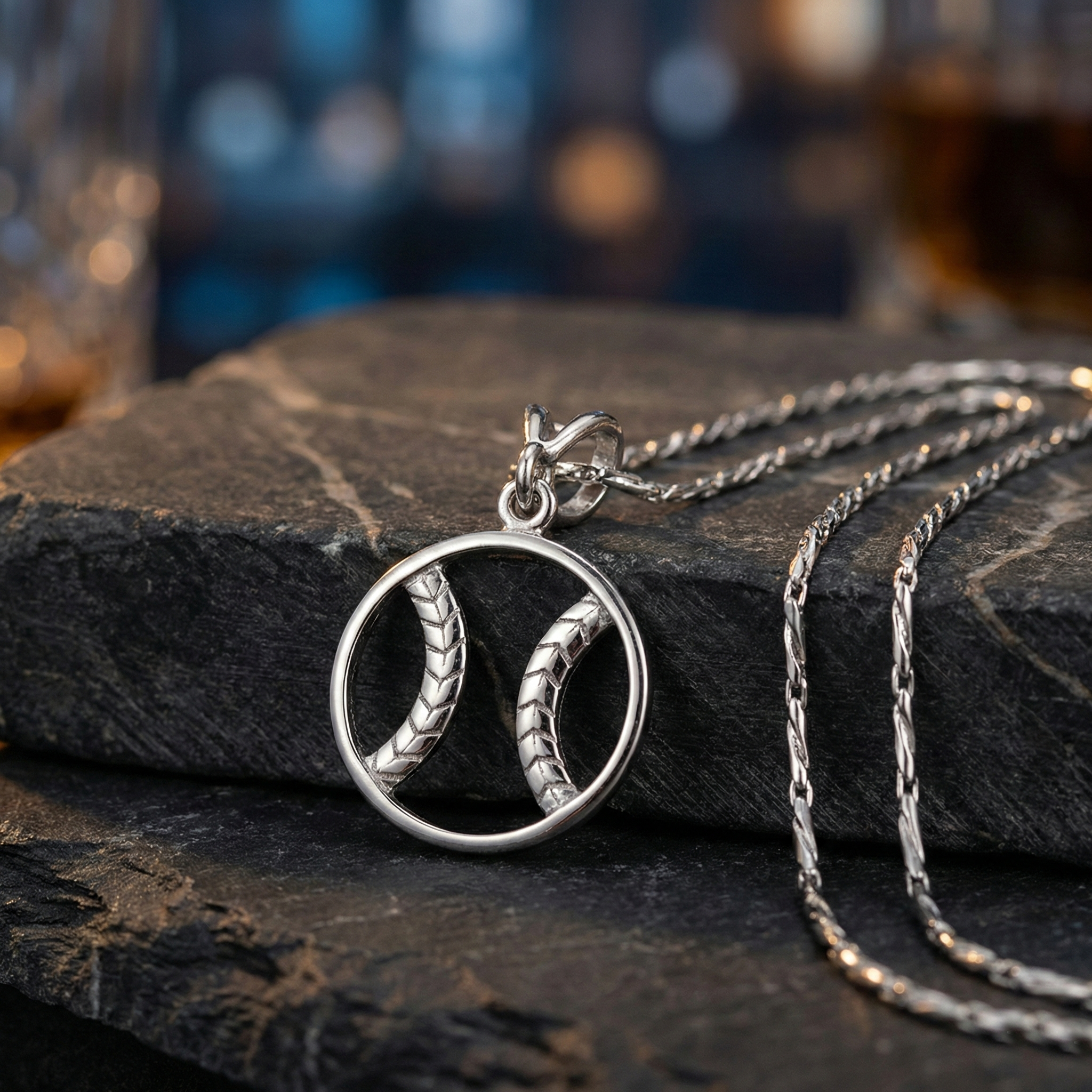 Sterling silver baseball zen necklace with a unique pendant on a dark stone surface