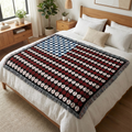 Bed with an American flag baseball patterned tapestry throw blanket in a bedroom setting.