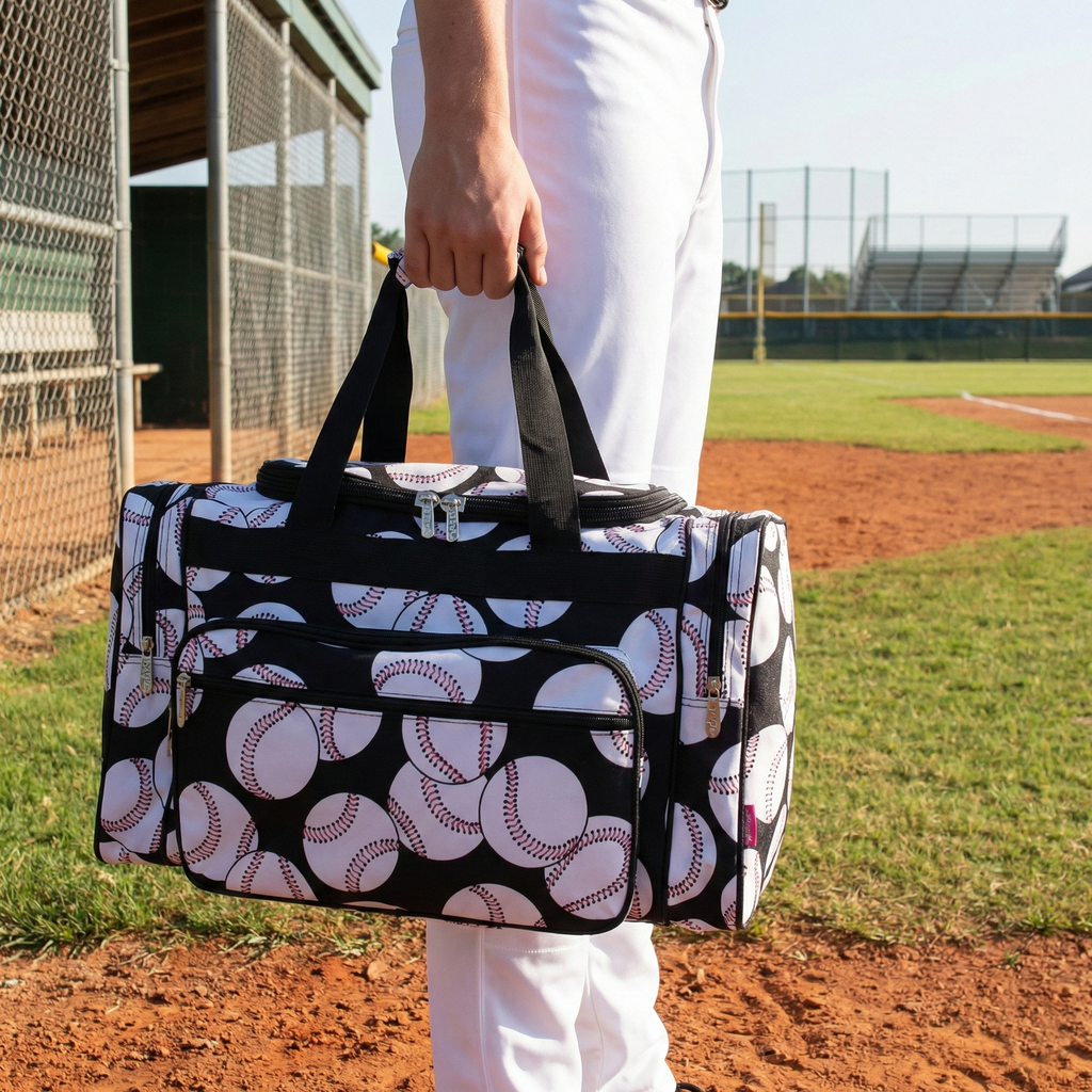 Person holding a bag with baseball pattern on a baseball field
