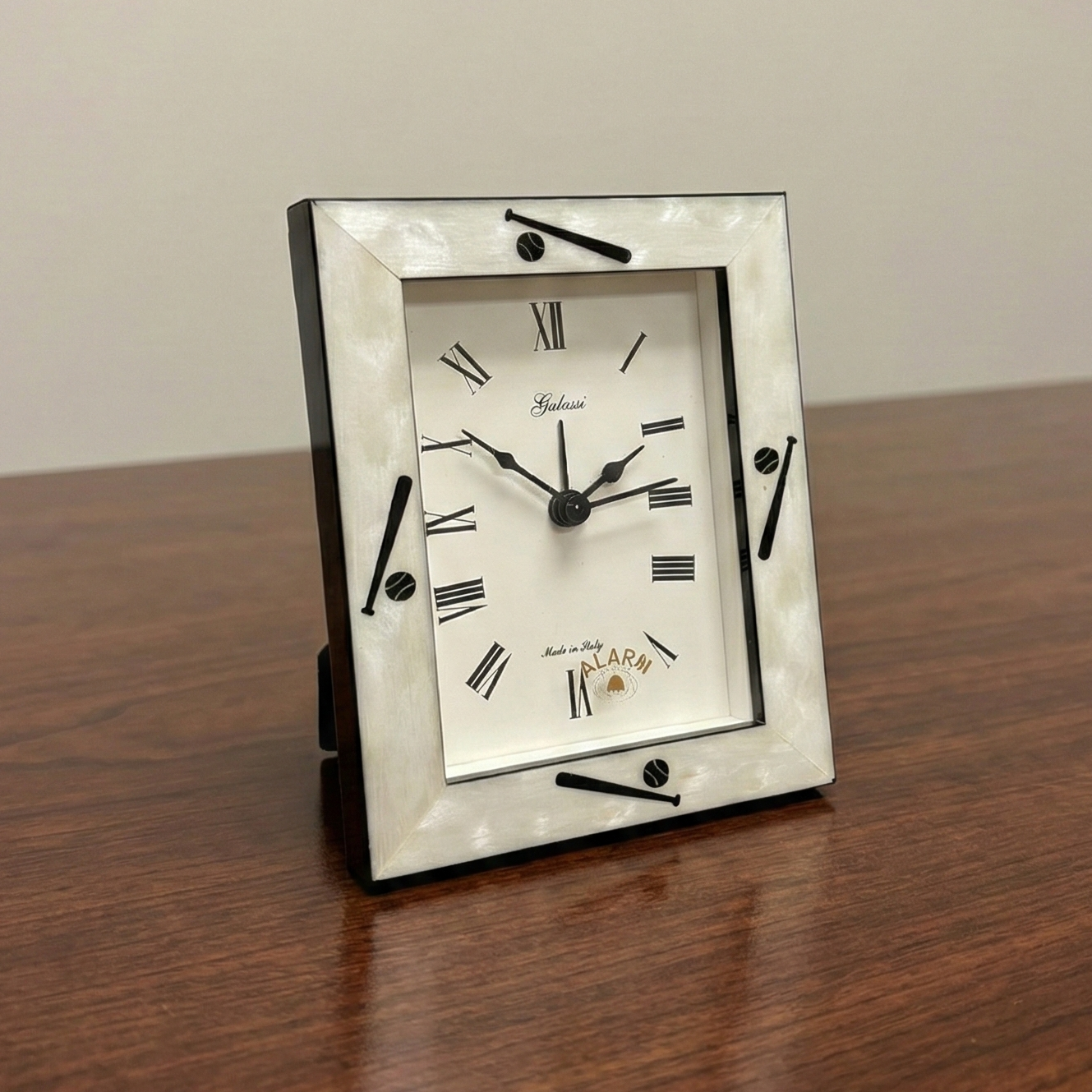 Decorative baseball alarm clock with a silver frame on a wooden surface