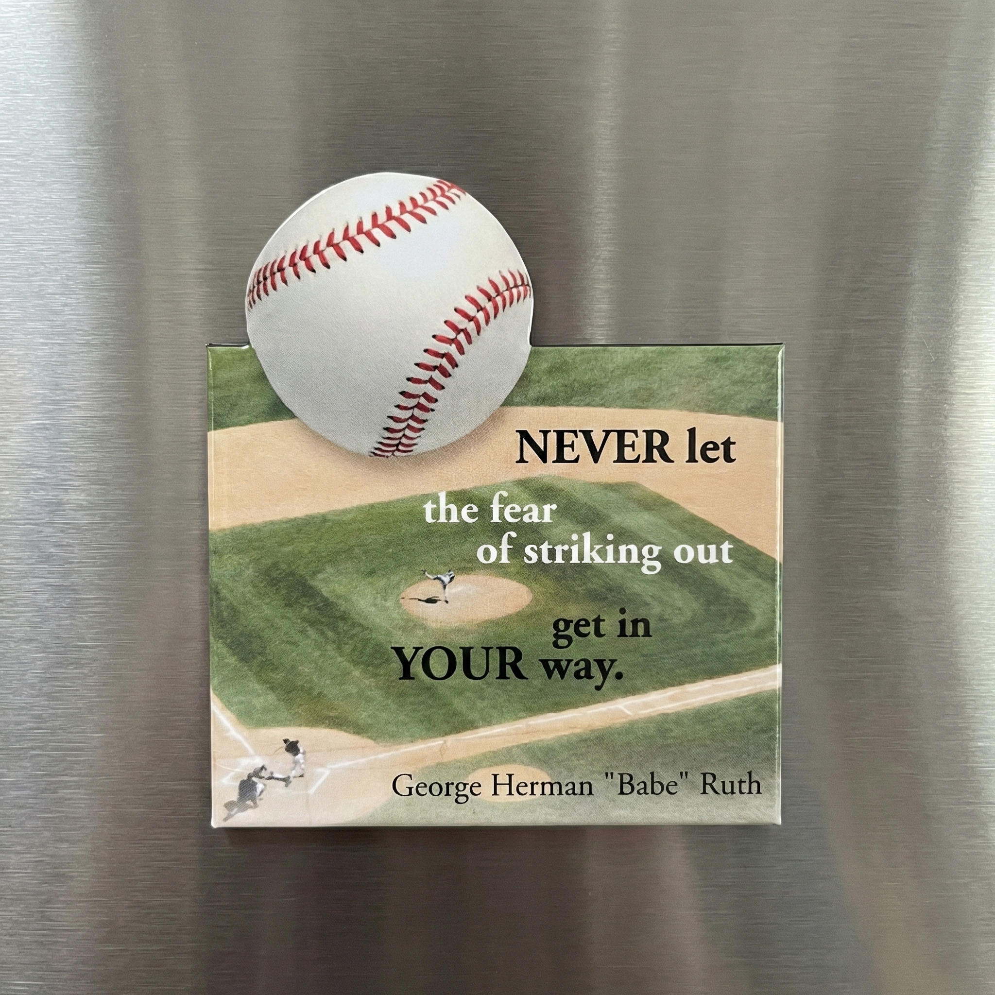 Baseball-themed magnet with a baseball illustration and a quote on a metallic surface
