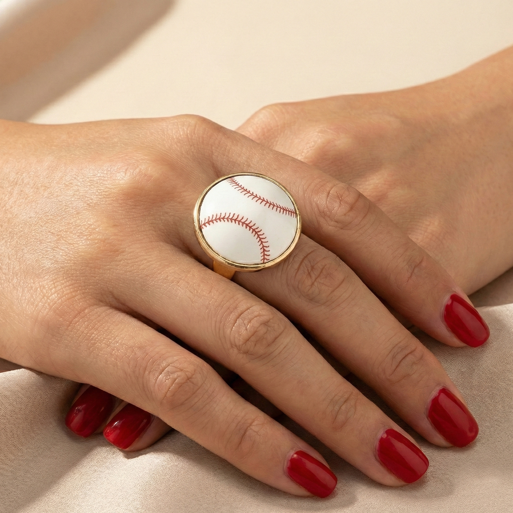 Ring with a baseball design on a hand with red nail polish