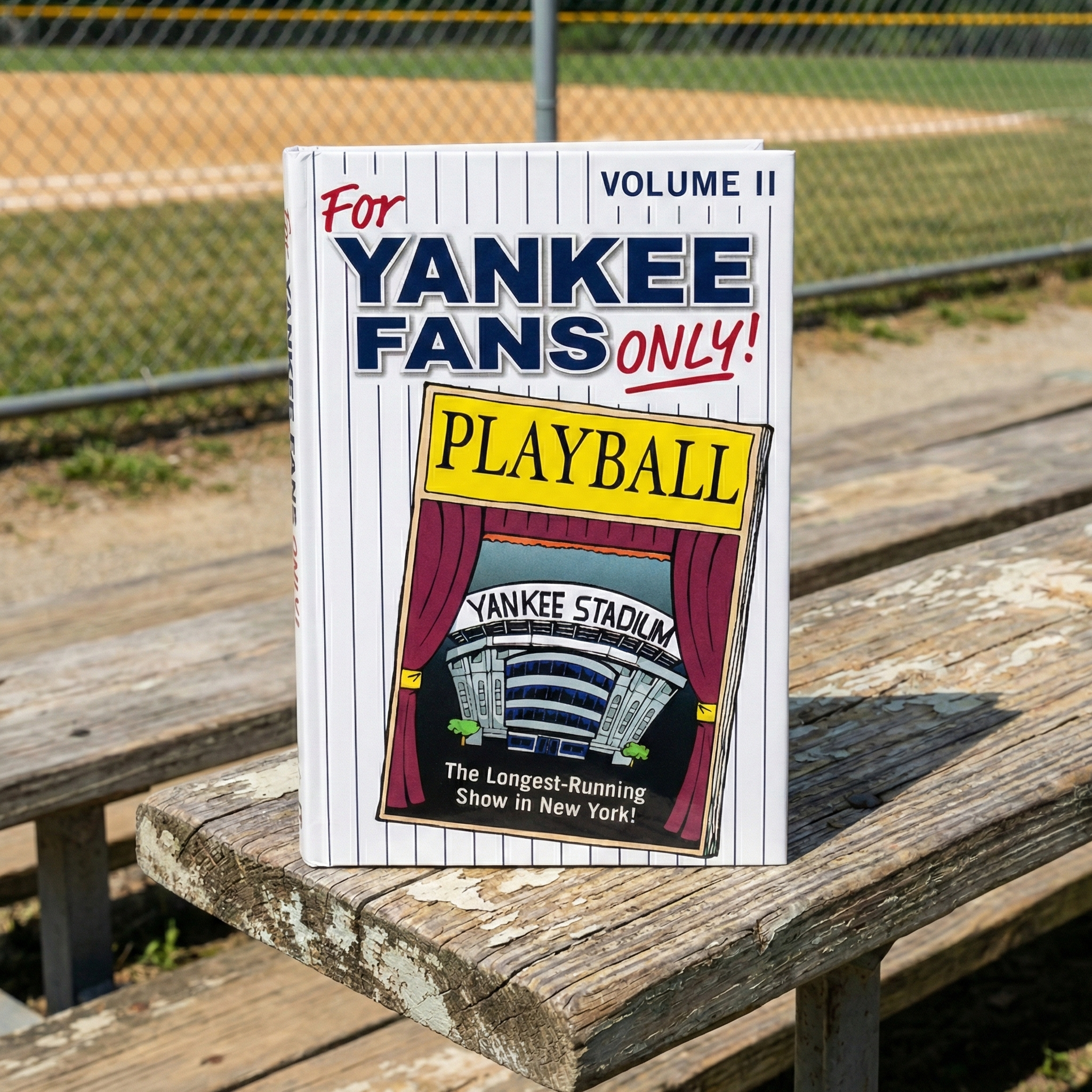 For Yankee Fans Only II 2 on a wooden bench with a baseball field background.