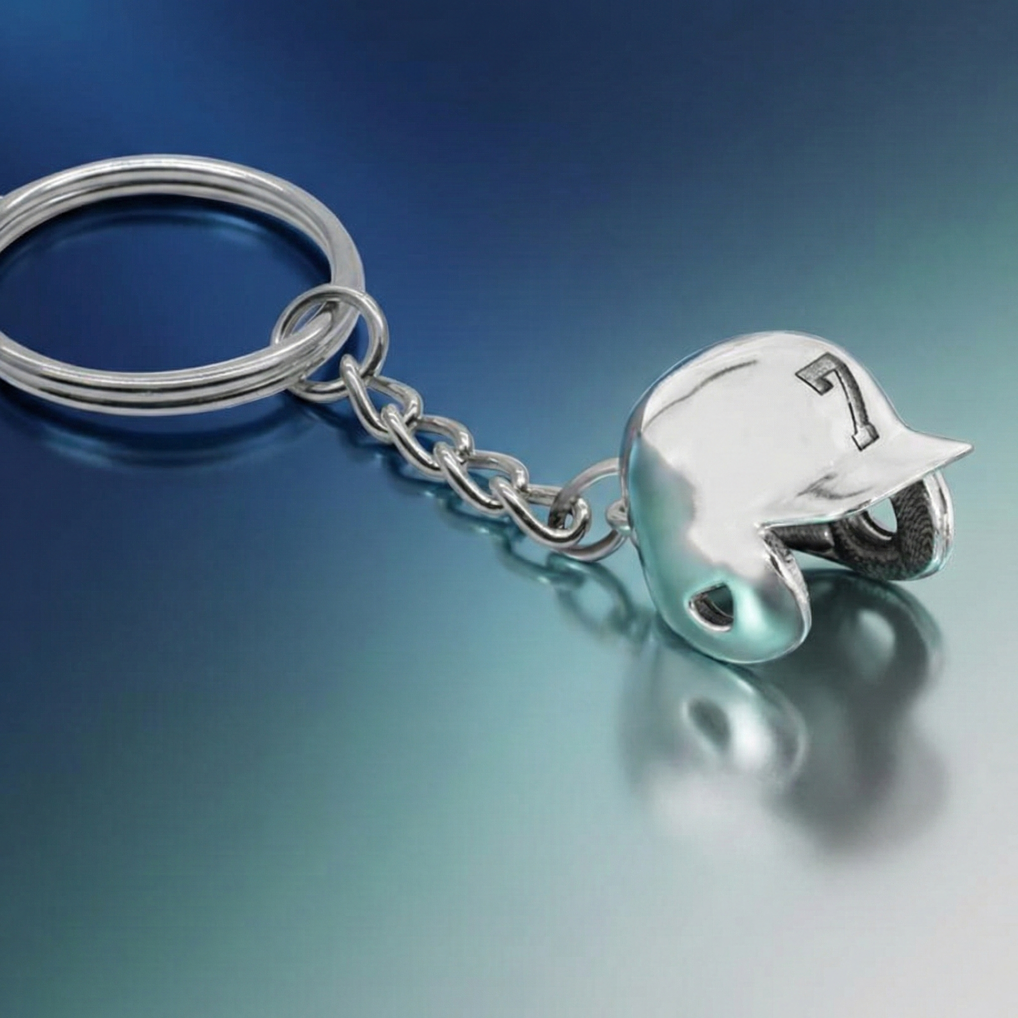 Silver sports number keychain with a baseball helmet-shaped charm on a gradient blue background