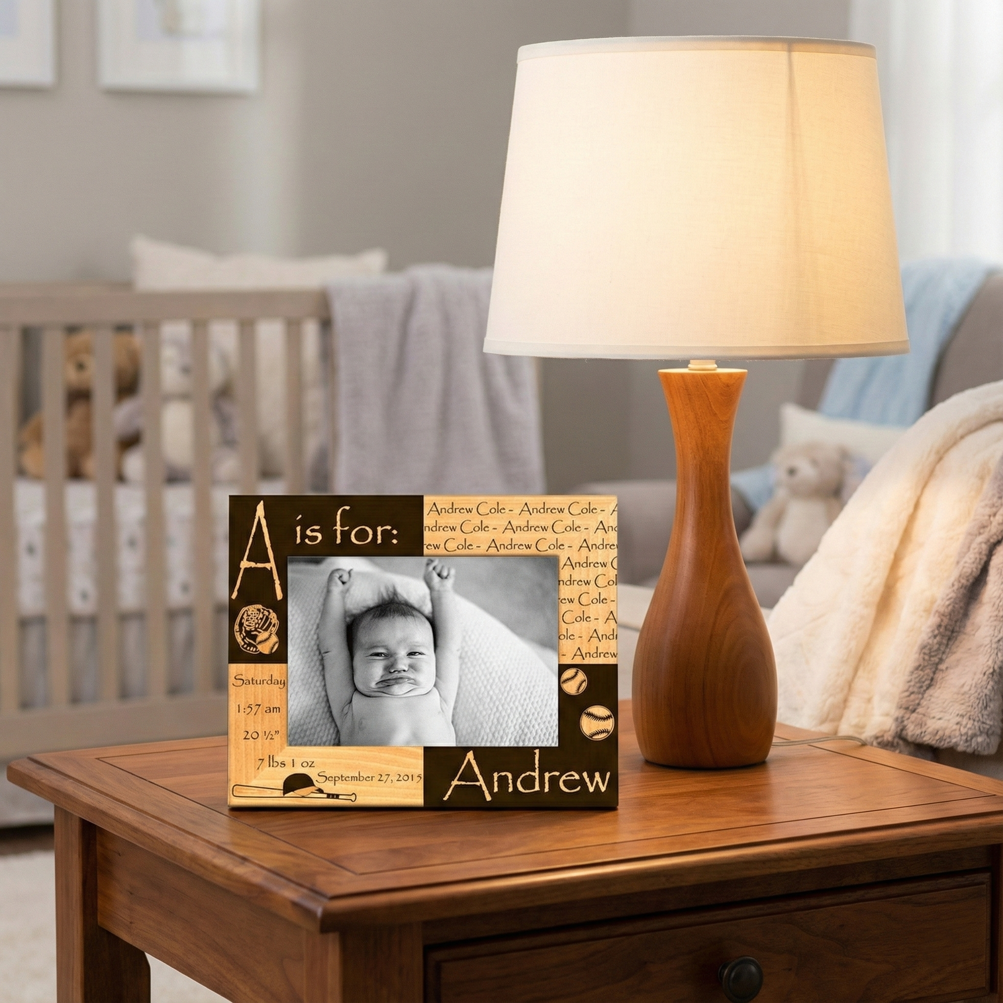Personalized baseball baby photo frame on a wooden table with a lamp in a nursery setting