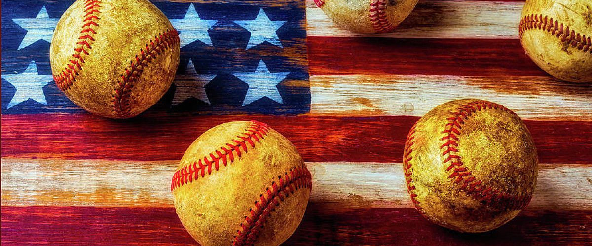 Baseballs on a wooden surface with an American flag pattern