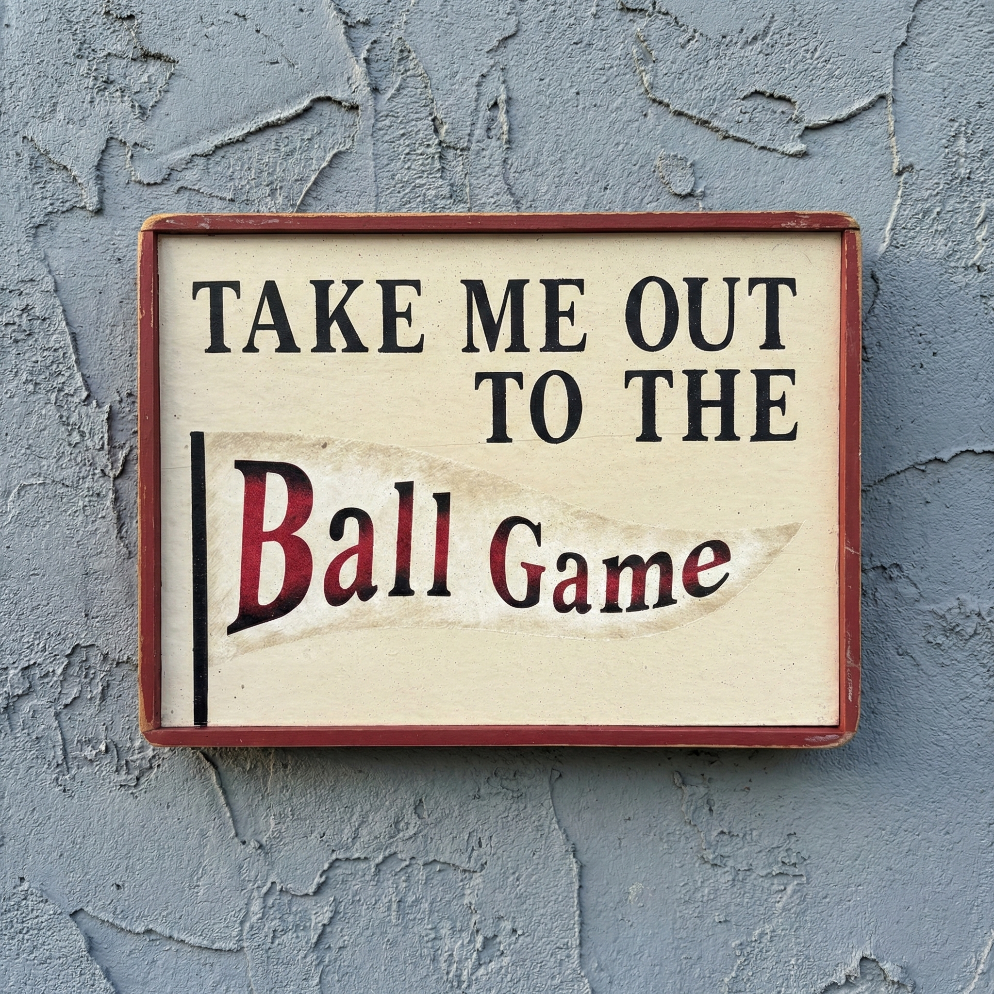 Wooden sign with 'Take Me Out to the Ball Game' text on a textured wall.