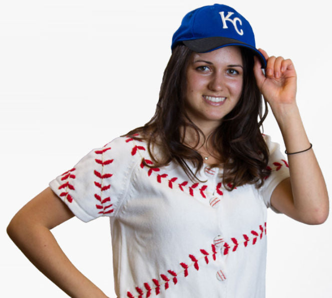 Woman wearing a baseball-themed shirt and Kansas City Royals cap on a white background