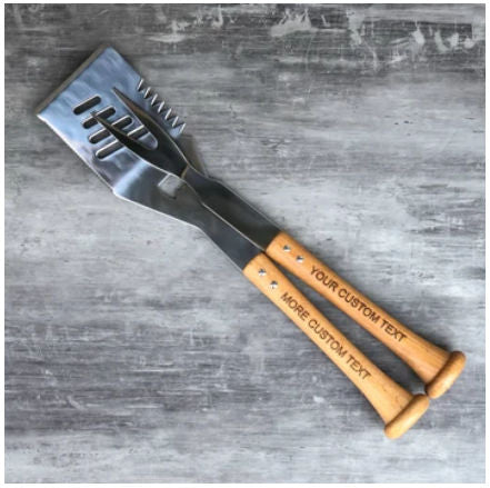 Barbecue utensil with baseball bat wooden handle on a gray surface
