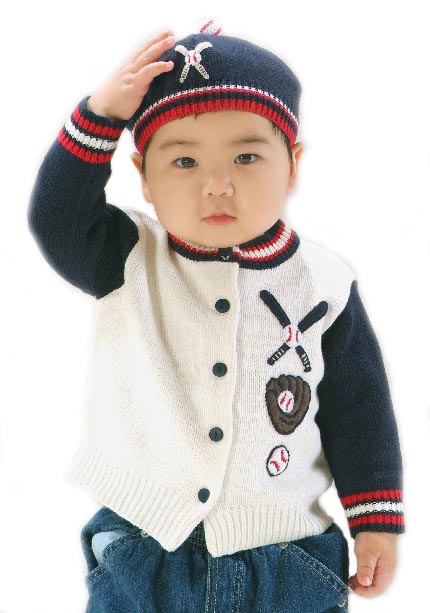 Child wearing a stylish cardigan with baseball-themed designs on a white background
