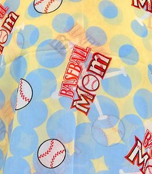 Fabric with 'Baseball Mom' text and baseball graphics on a yellow and blue polka dot background.