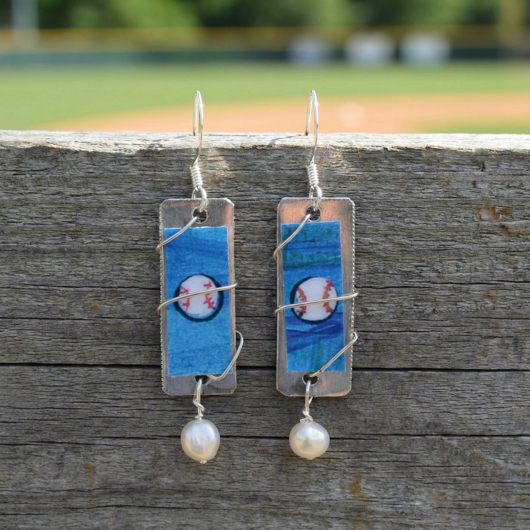 Handmade Baseball Art Dangle Earrings on wood surface at the ball field