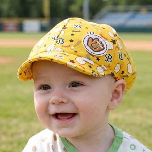 Yellow baseball baby hat on a baby at the baseball field