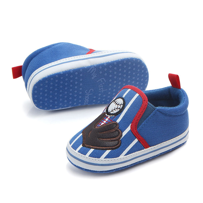 Blue baby baseball slipper shoes with red accents and a character patch on a white background
