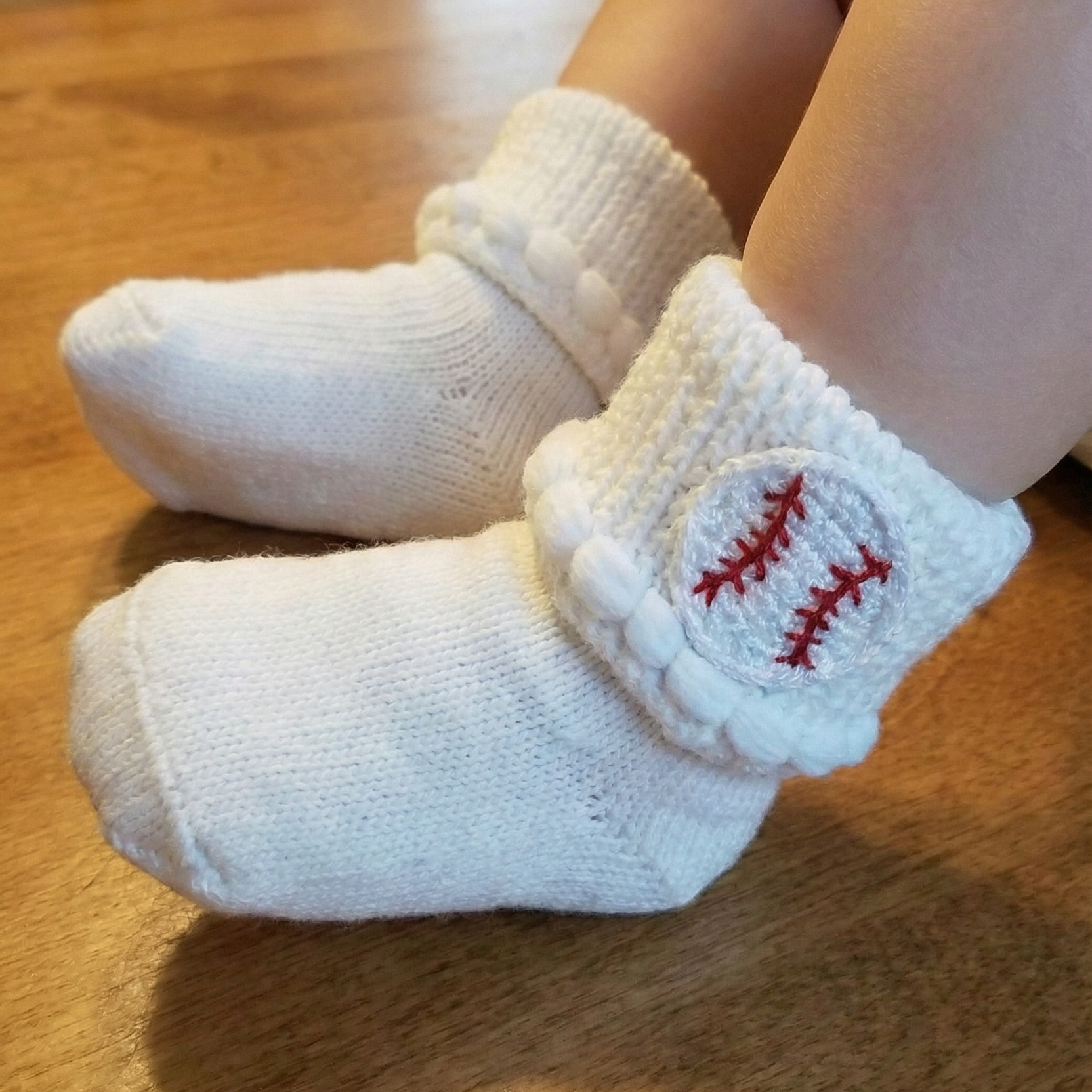 Baby Boutique Baseball Baby Socks with crocheted baseballs on baby feet
