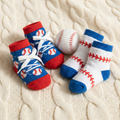 2 pairs of baseball baby socks on a baby blanket