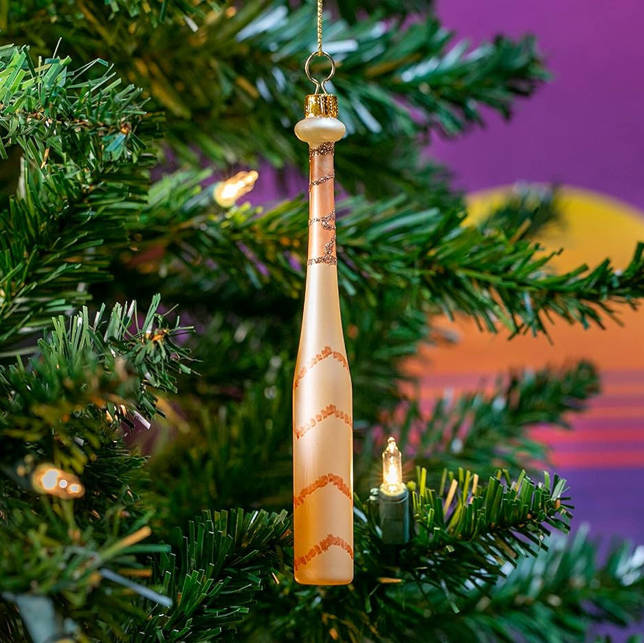 Decorative baseball bat shaped ornament on a Christmas tree with a colorful background