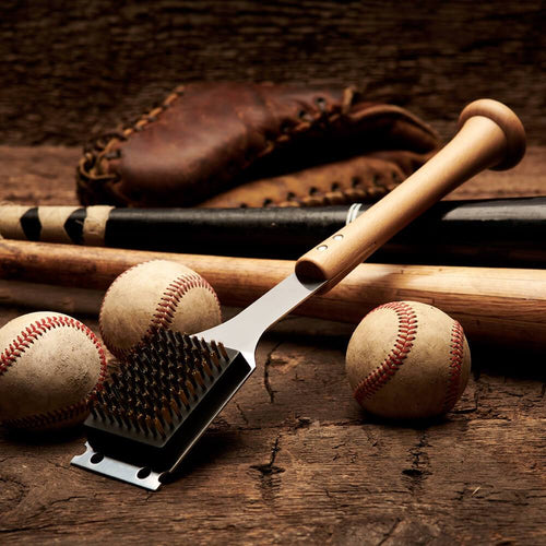 Barbecue grill brush with baseballs and bats on a wooden surface