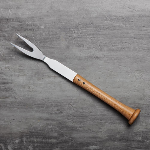 Barbecue grill fork with wooden baseball bat handle on a gray surface