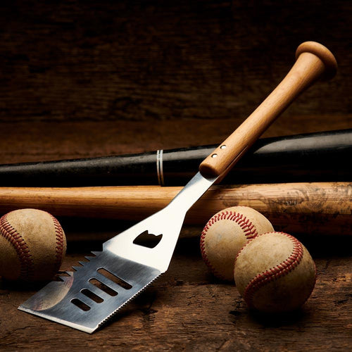 Barbecue bat handle grill spatula with baseballs and bats on a wooden surface
