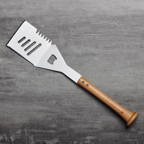 Barbecue grill spatula with wooden baseball bat handle on a gray surface