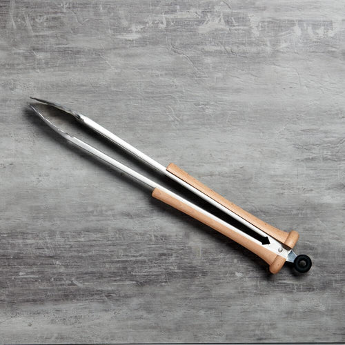 Grill tongs with wooden baseball bat handle on a gray textured surface