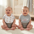 Twins wearing Mud Pie Little Slugger Baseball Bibs in the bedroom